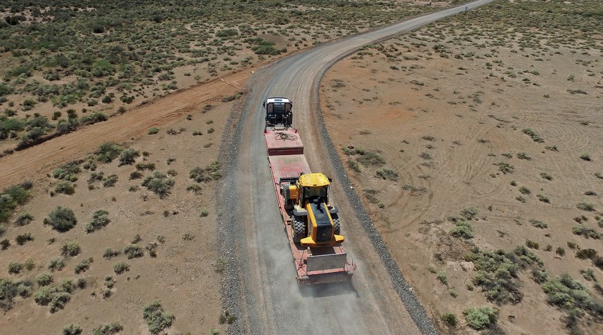 cross country excavator hauling